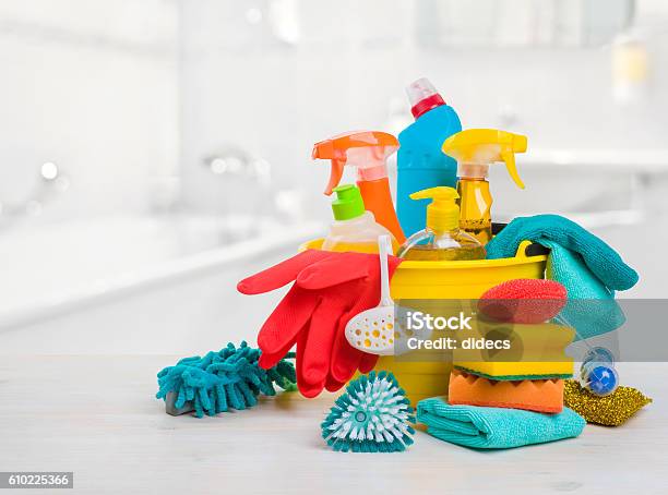 Bucket With Chemical Products On Table Over Blurred Bathroom Background Stock Photo - Download Image Now