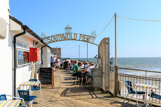 Southwold Pier, Suffolk, UK Southwold, UK - August 17, 2016 - Tourists walking around on the Southwold Pier southwold stock pictures, royalty-free photos & images