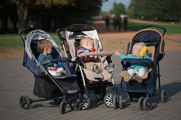 Motion blurred people with child strollers crossing street