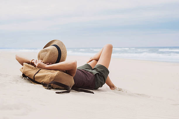 istock Young woman lying on a beach 610227130