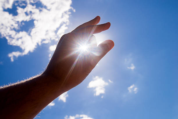 istock Catching the Sun at sunset  from a man's hand 610227272