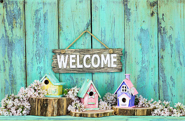istock Welcome sign hanging over birdhouses 610227452