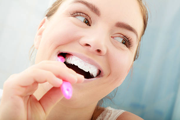 istock Woman brushing cleaning teeth. Oral hygiene. 610228096