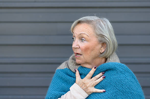 istock Startled elderly woman clasping her chest 610228278