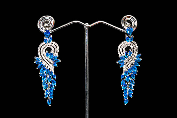 istock Earrings with blue stones isolated on black, close-up 610229194