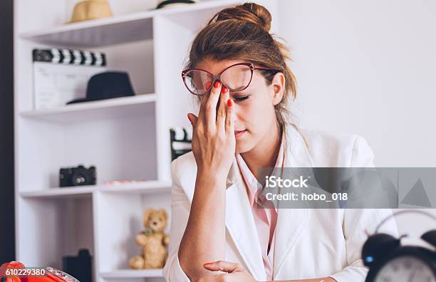 Young And Beautiful Businesswoman Tired From Work In The Office Stock Photo - Download Image Now