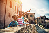 Family sightseeing charming little Italian town in Tuscany