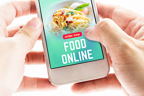 istock Close up Two hand holding mobile phone with food online 610230366