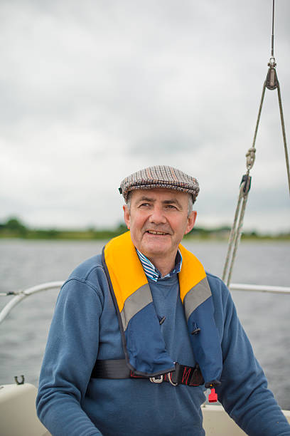 istock Smiling senior man on yacht 610230612