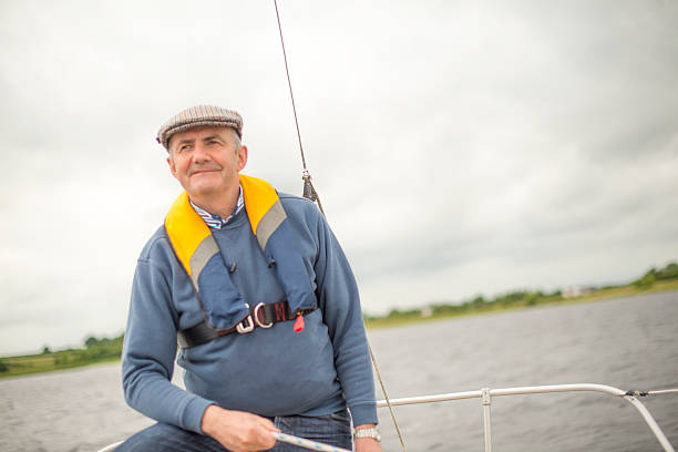 istock Smiling senior man sailing in open waters 610232206