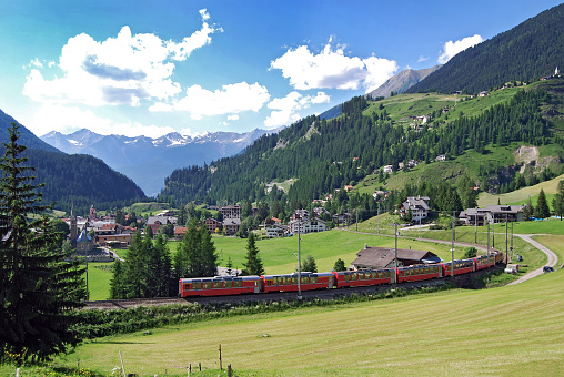 The Bernina Express from the Rhaetian Railway near the railway station of Bergün. This railway station is located on the Albula Railway line from Chur to St. Moritz. The Bernina Express is connecting Chur in Switzerland and Tirano in Italy. the train runs along the World Heritage Site known as the Rhaetian Railway in the Albula / Bernina Landscapes.
