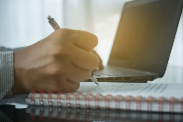 istock Close up man note memo in book for business analysis 610235778
