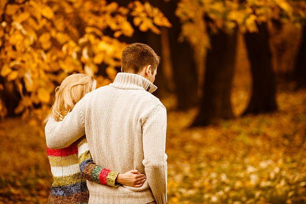 istock Couple walking in autumn park 610235892