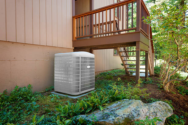 Heating and air conditioning units A residential central air conditioning and heating unit sitting outside a home. oil pump photos stock pictures, royalty-free photos & images