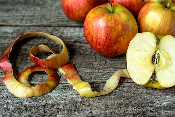 istock Whole apples and cut in half apple on wooden background 610236910