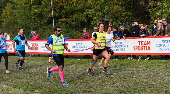 Stockholm, Sweden - September 24, 2016: Sightless man with his escorts crosses the finish line in the race, TCS  Lidingöloppet