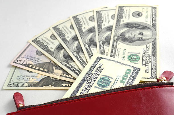 istock Several dollar bills in a red woman's purse 610239150