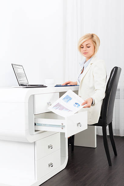 istock business woman hide document in desk box 610239184