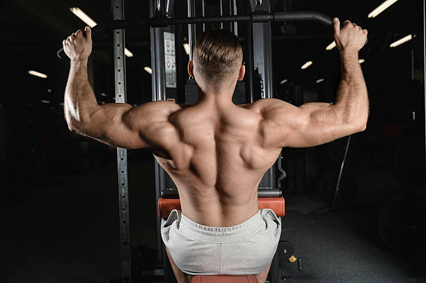 istock Handsome muscular bodybuilder man doing exercises in gym 610239236