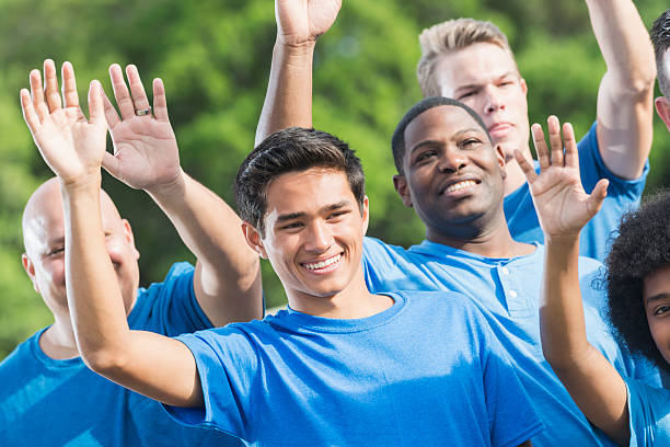 istock Group of volunteers raising hands 610241060