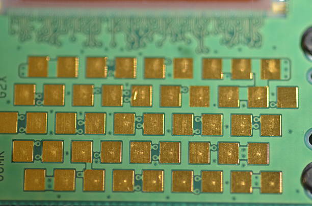 istock Staggered rows of square gold contacts on circuit board 610242218
