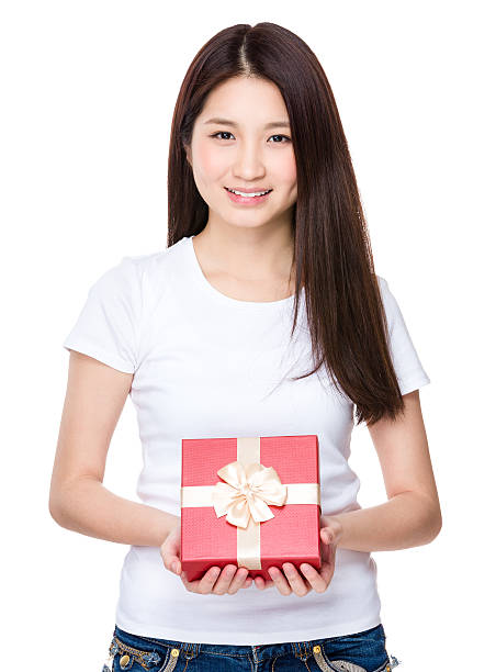 istock Woman holding a gift box 610243652
