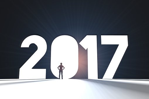 A female figure is standing in front of a large 2017 message. new year opportunity concept