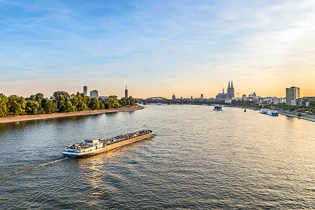 skyline of Cologne with river Rhine skyline of Cologne with river Rhine in late afternoon rhine river photos stock pictures, royalty-free photos & images