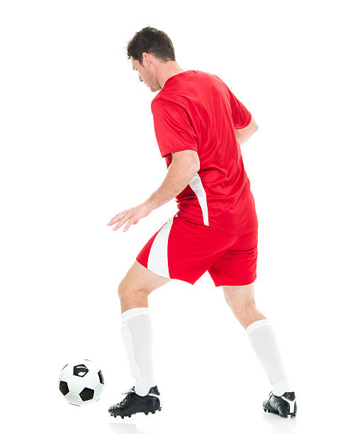 istock Rear view of soccer player dribbling 610246302
