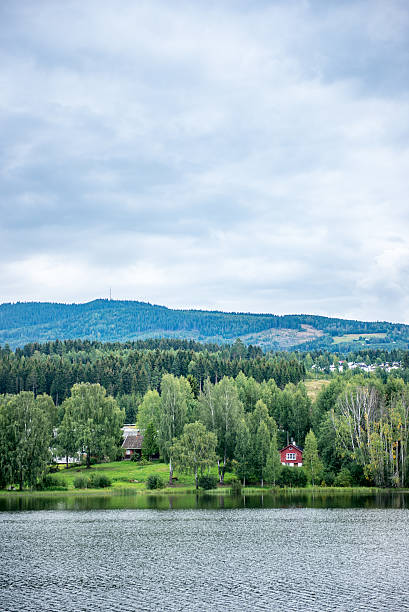 istock Little Red House on a Norwegian Lake 610246696