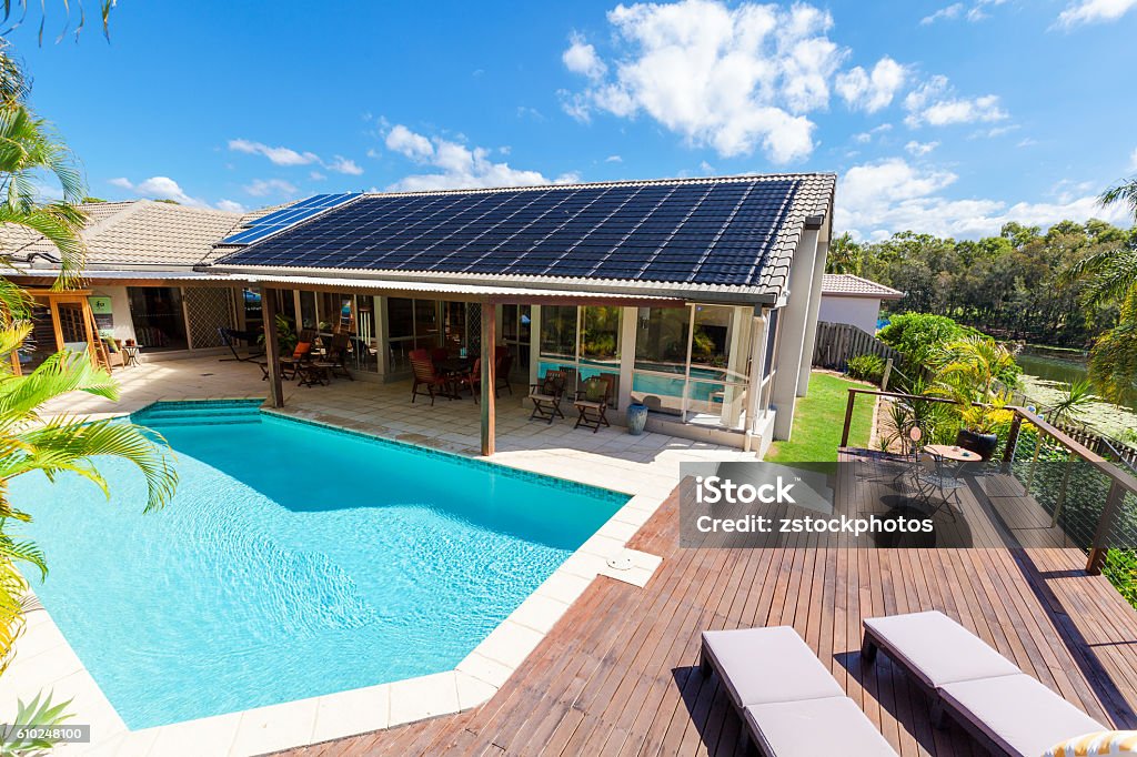 Backyard with swimming pool Backyard with swimming pool in stylish home Solar Panel Stock Photo