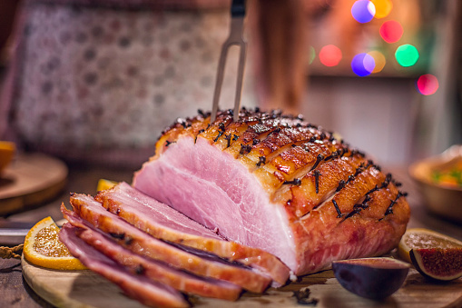 Carving Delicous Glazed Holiday Ham with Cloves