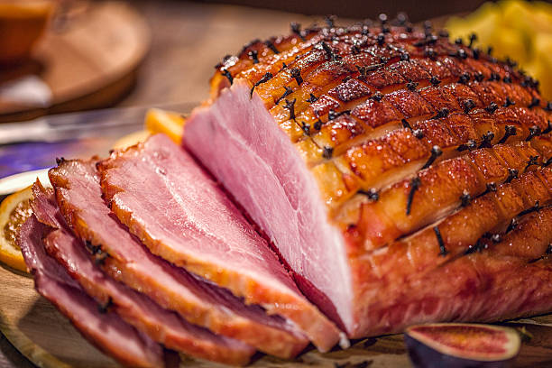 Glazed Holiday Ham with Cloves Served for Dinner stock photo