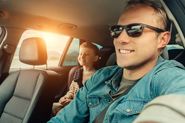 istock Father with son go in car 610252928
