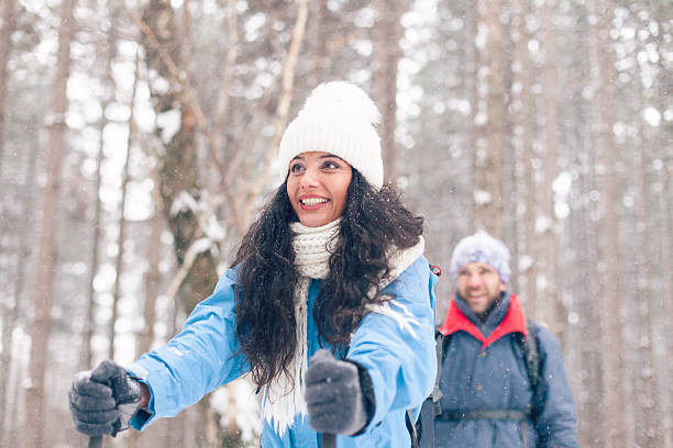 istock Two young people skiing in the snow forest 610253234
