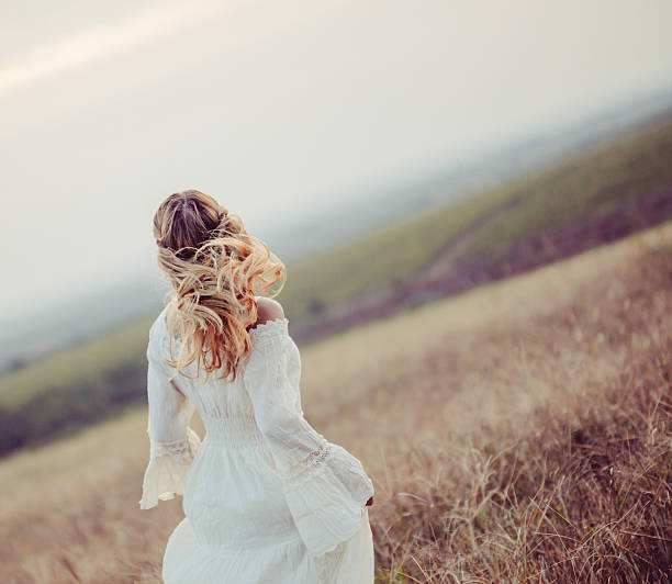 istock Young woman in a meadow 610253668