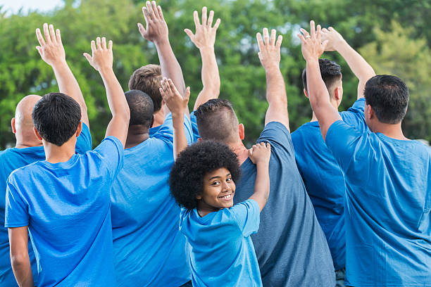istock Boy with group of men volunteering 610253842
