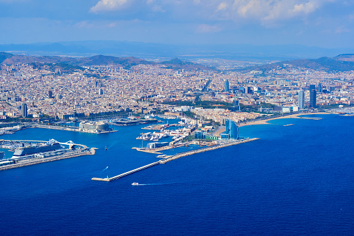 Barcelona's aerial views from the sea. Sunny day with nice soft clouds in the sky. 