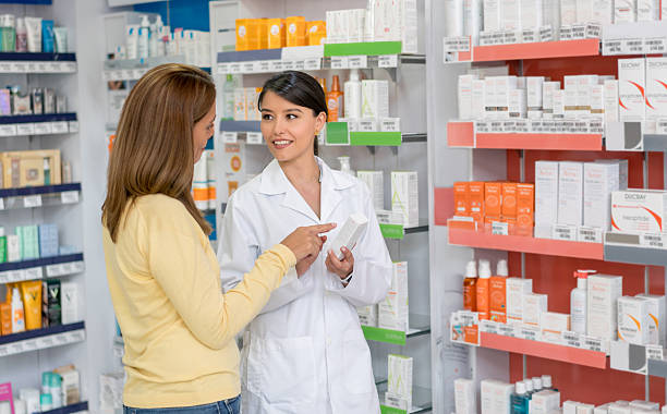 istock Pharmacist helping customer at the pharmacy 610254458