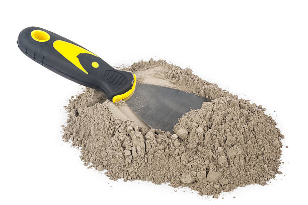 istock Gray cement powder with trowel 610254482