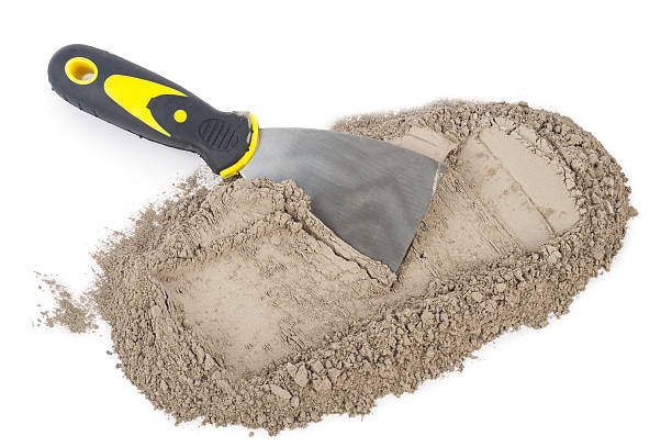 istock Gray cement powder with trowel 610254988