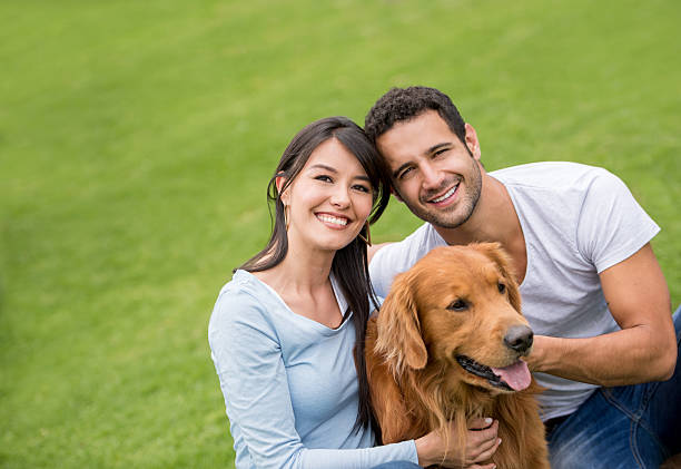 istock Couple with their dog at the park 610255072