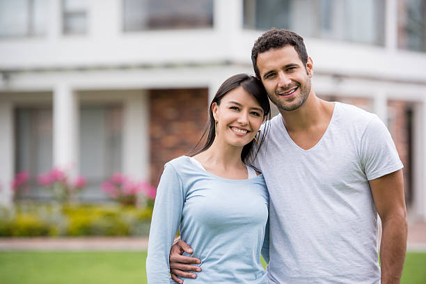 istock Happy couple outside their house 610255082