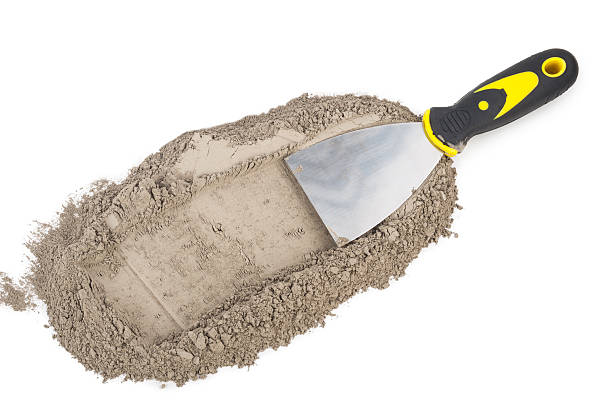 istock Gray cement powder with trowel 610255468