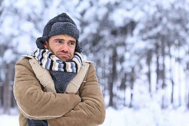 istock Young man shivering in snow forest 610255722