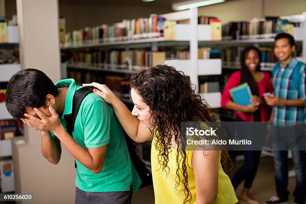 Female Student Helping Sad Friend Stock Photo - Download Image Now - Bullying, Assistance, Incidental People