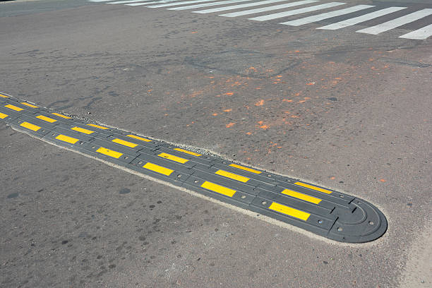 istock Traffic safety speed bump with crosswalk on an asphalt road. 610256366