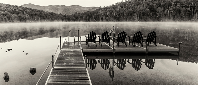Black & white panorama of the Heart Lake dock on a misty morning in the High Peaks region of the Adirondack Mountains near Lake Placid, NY
