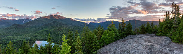 High Peaks Sunset Panorama from Mount Jo A sunset panoramic view from the summit of Mount Jo, overlooking Heart Lake, Mt. Colden, and Algonquin and Wright Peaks in the High Peaks region of the Adirondack Mountains near Lake Placid, NY state park photos stock pictures, royalty-free photos & images
