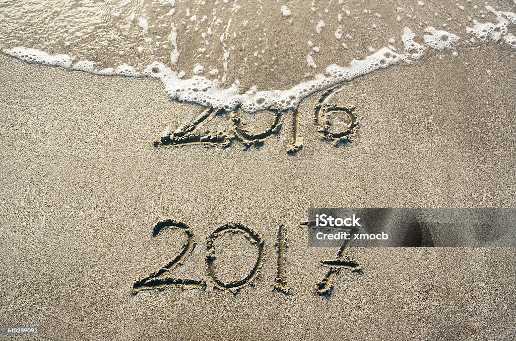 Good bye 2016 hello 2017 Good bye 2016 hello 2017. 2016 handwritten text numbers washed by wave. 2016 Stock Photo